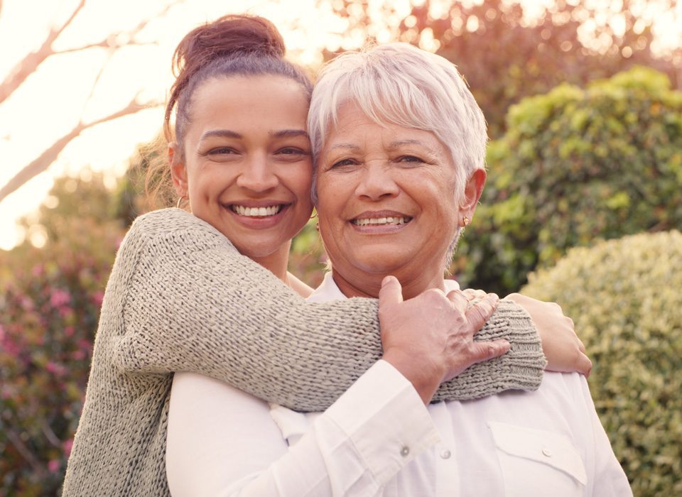 Two women hugging each other